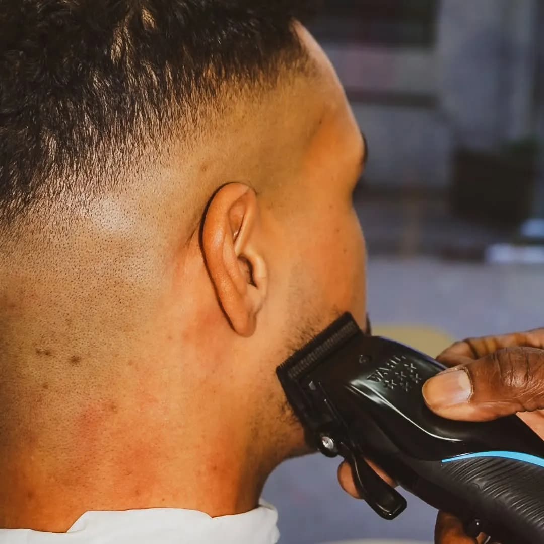 Fade haircut in progress with clippers at Barberhood Toronto