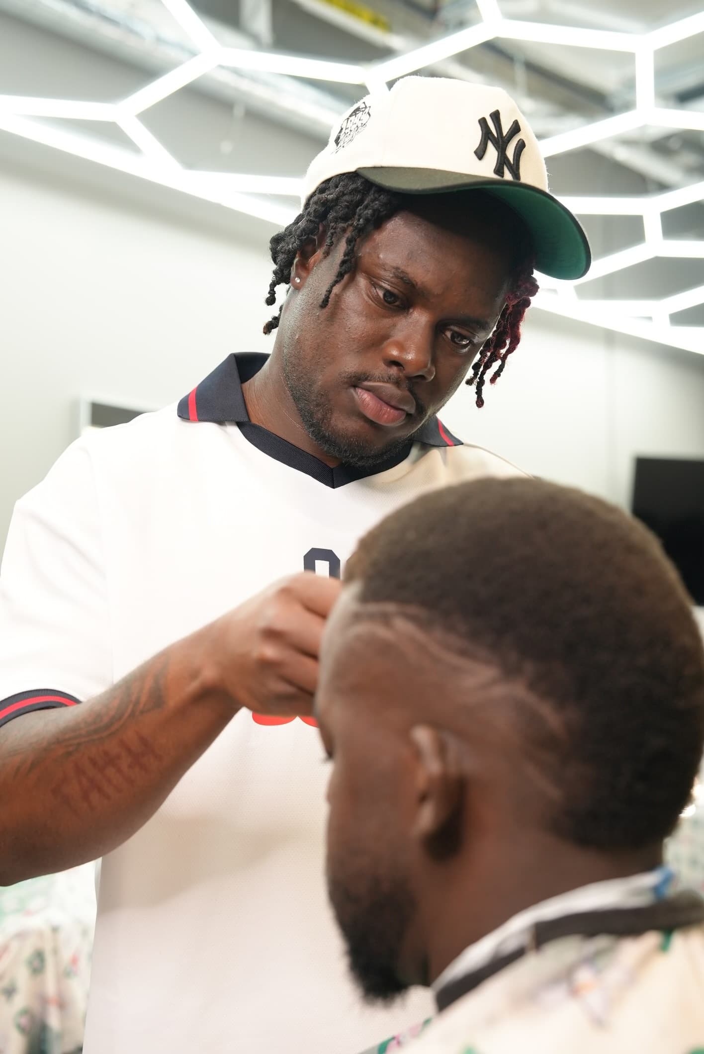 Simba checking the final result of a fade at Barberhood York U