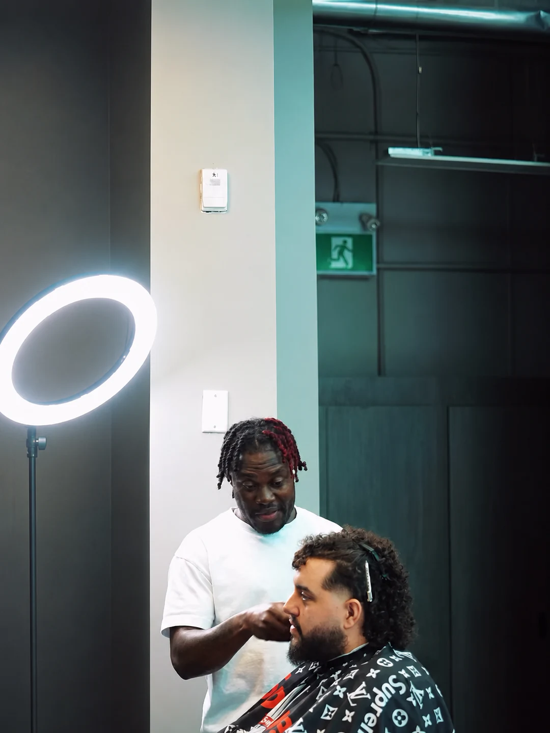A Barberhood York U barber working with an adult client inside the North York shop